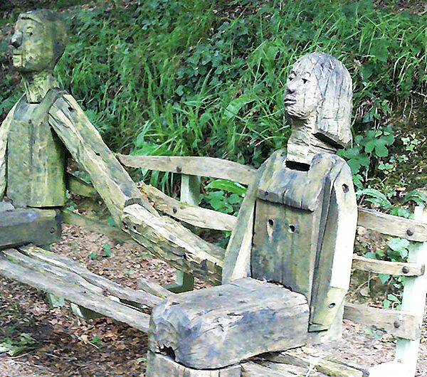 Wooden carvings of a young couple courting on the Tarka Trail near Torrington