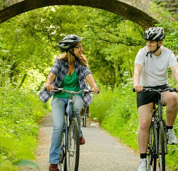 A couple cycling along the Tarka Trail between Braunton and Meeth